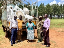 The District vice chairperson (blue dress) , Deputy RDC(left) with the principle Agric officer receiving cuttings from supplier.